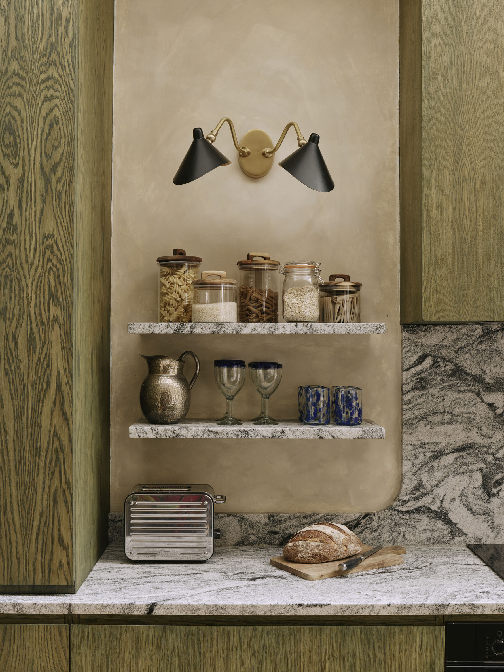 Details shot showing shelves with glass jars of food, interior design by Studio Squire