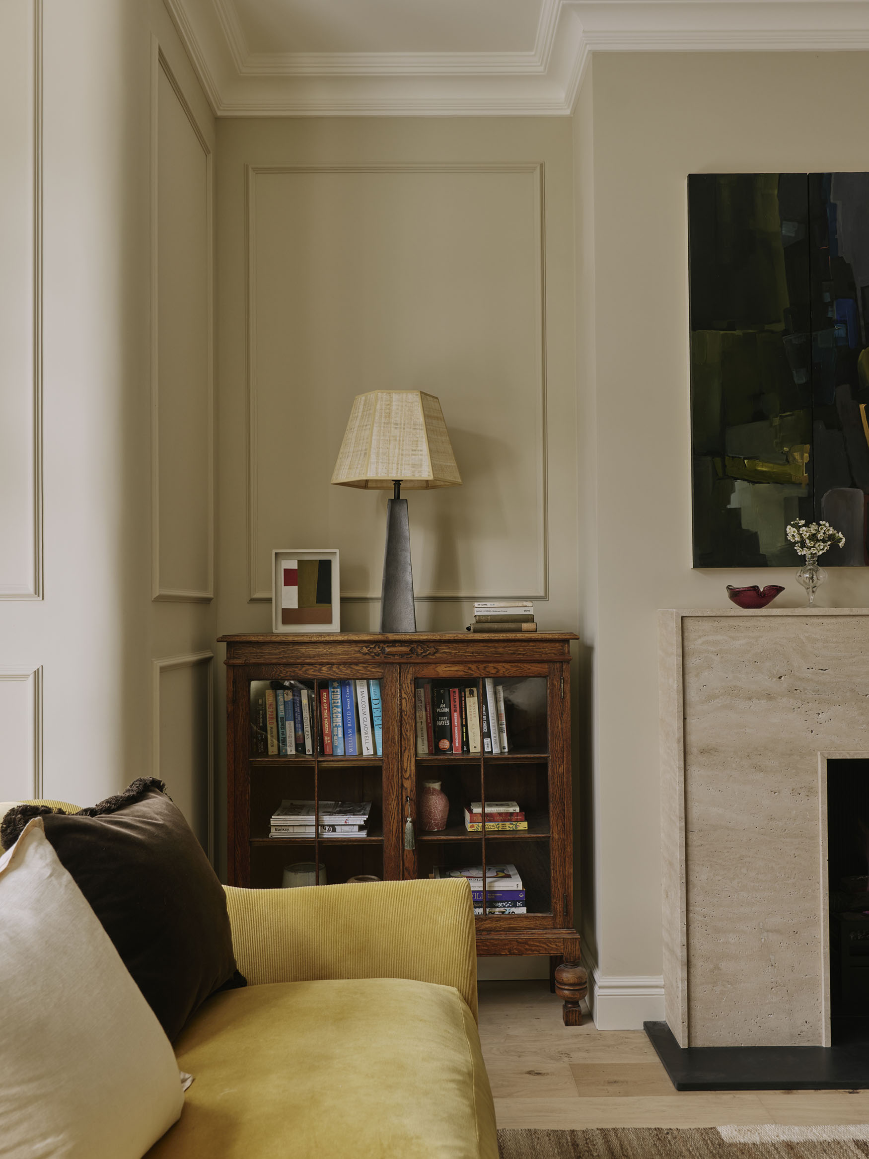 Detail showing a dark wood cupboard and lamp, interior design by Studio Squire
