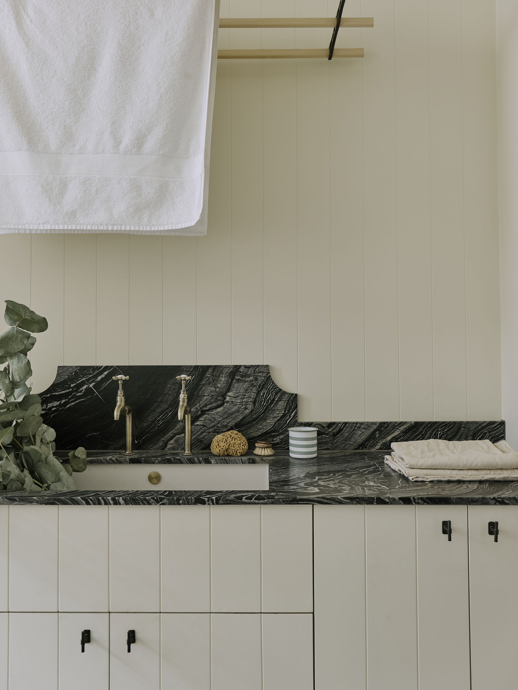 Utility sink with marble counter, interior design by Studio Squire