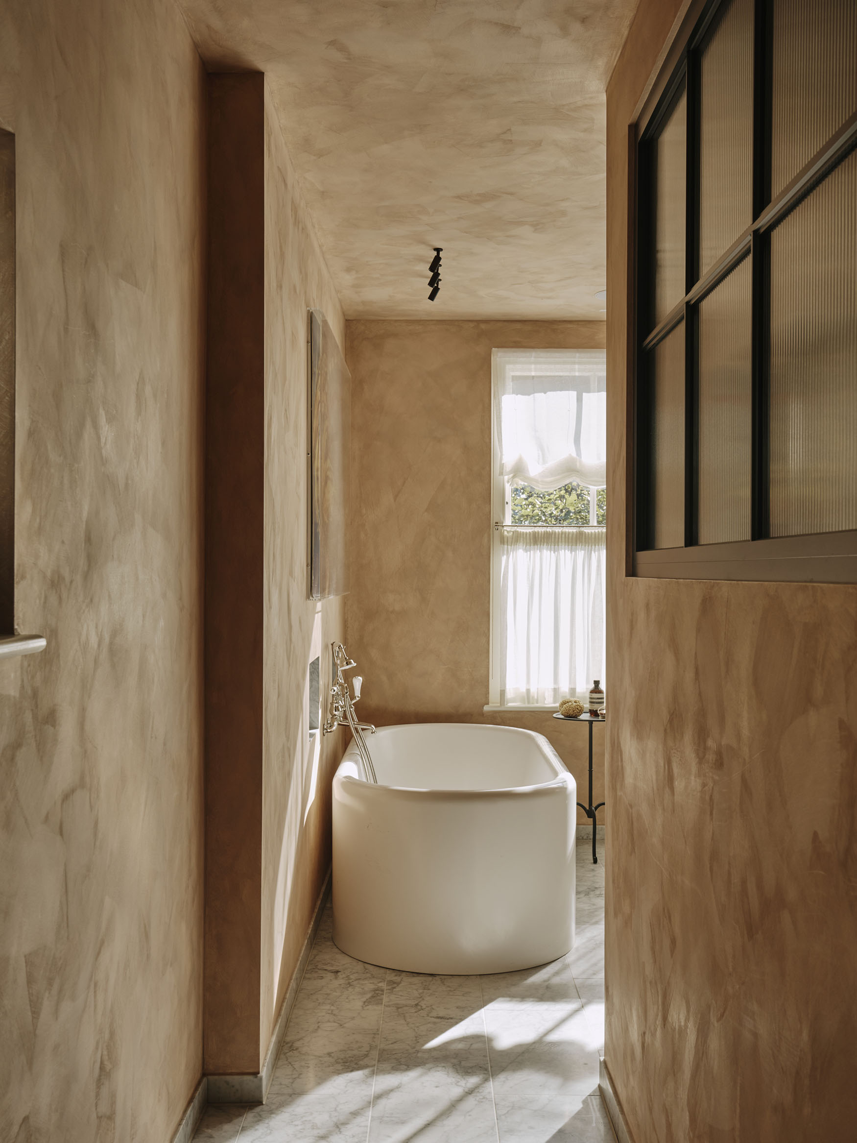 Image showing a white bath in a pink bathroom, interior design by Studio Squire