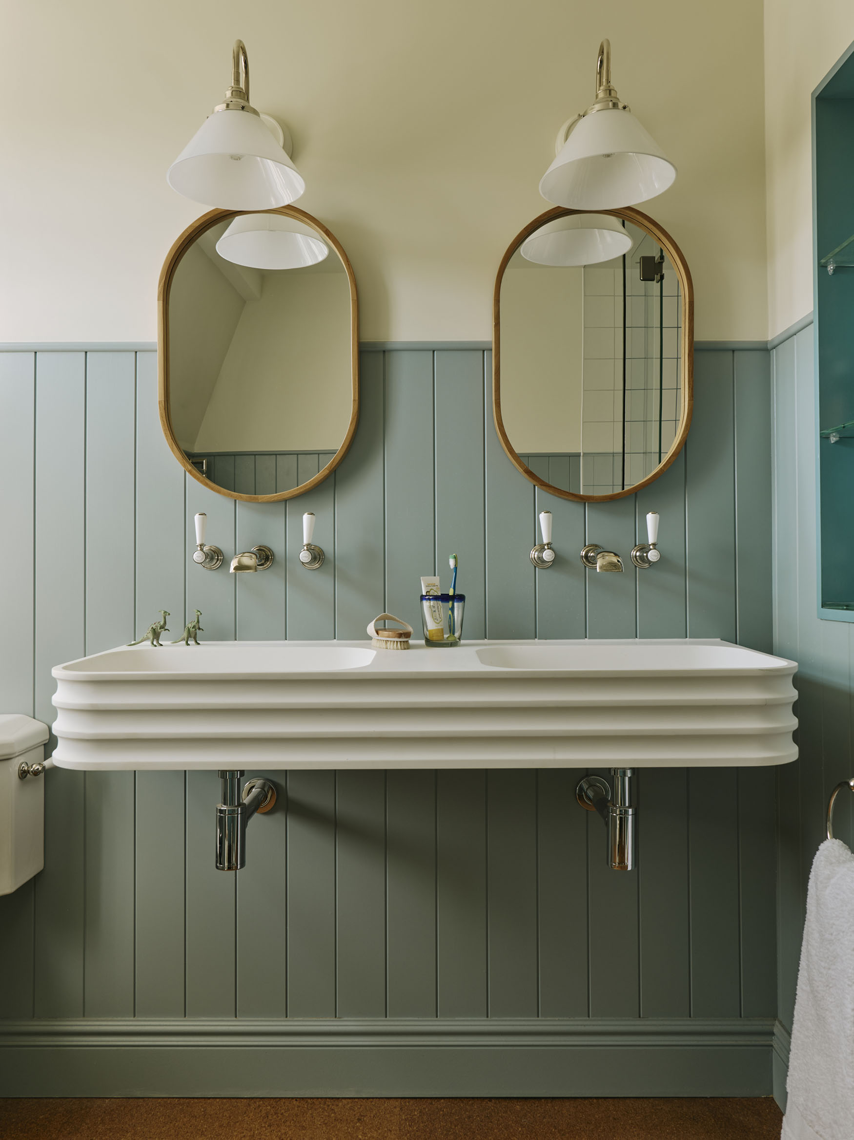 Double sink with blue panelling, interior design by Studio Squire